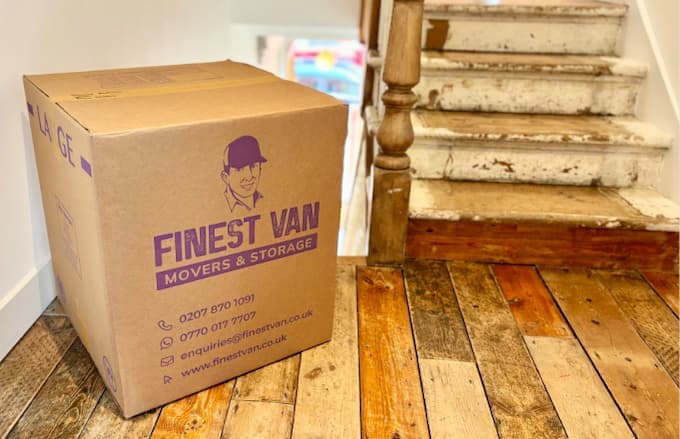 Packed moving box upstairs during a family house move